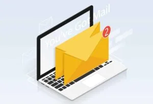 A laptop with two email envelopes standing on the keys.