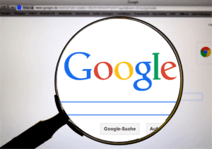 A magnifying glass displaying the Google Search website.